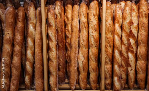 Wallpaper Mural Row of bread loaves are displayed in a wooden case. The loaves are all brown and appear to be freshly baked. Torontodigital.ca
