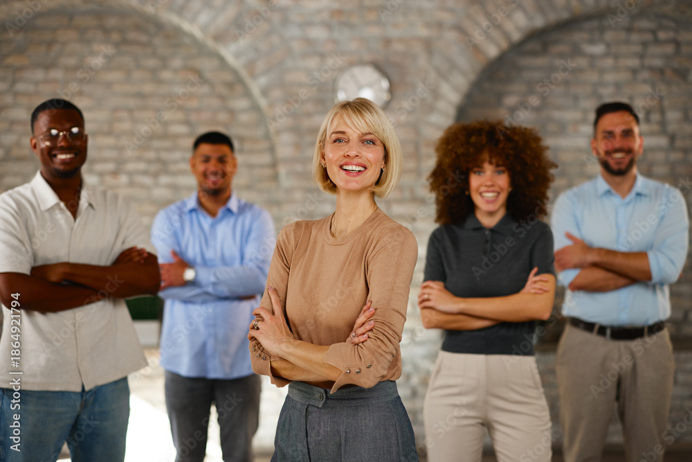 Obraz premium Confident diverse business team with folded arms smiling in office