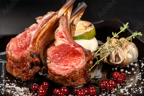 Wallpaper Mural Rack of Lamb - The meat is cooked to medium rare, giving it a pink hue and a tender texture. The dish is garnished with roasted garlic, red currants, and a sprig of rosemary Torontodigital.ca