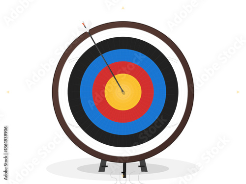 Target with an arrow in the bullseye at an archery range during daylight hours