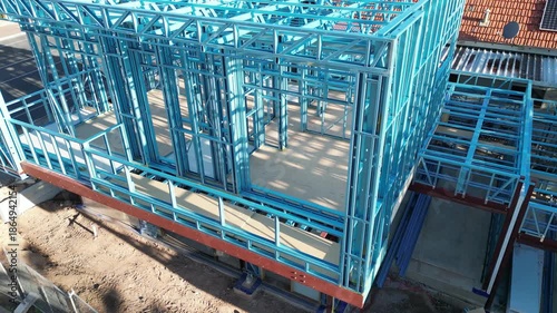 Steel frame house under construction, modern residential building site

