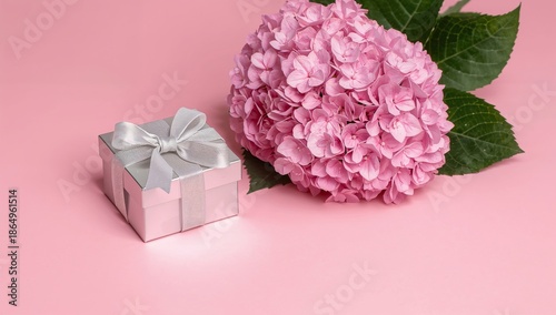 Gift Box and Pink Flowers on a Pink Background for a Special Occasion or Cele...