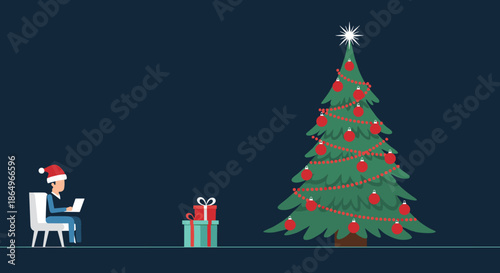 Young man wearing a Christmas hat works on his laptop near a decorated holiday tree and stacks of wrapped presents.