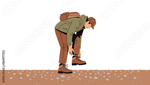 Man Securing Hiking Boots During Outdoors Adventure In A Rocky Terrain