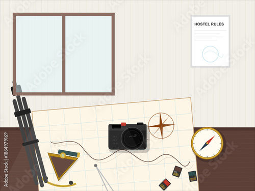 Items on a table in a room with a window and a notice about hostel rules