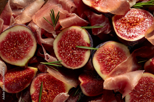 Bild auf Leinwand Prosciutto with rosemary and fig fruit.