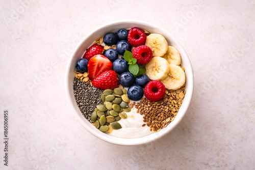 Healthy breakfast bowl with yogurt, granola and fresh berries on wooden table