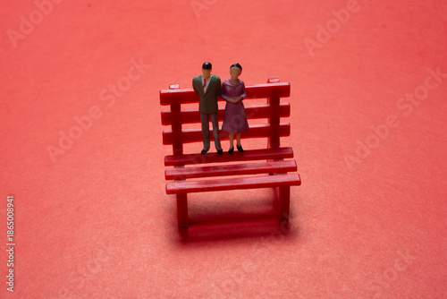 Statuette of people couple standing on bench