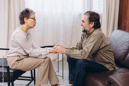 Psychologist offering counseling and support to mature man