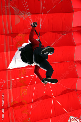 Colorful parachute at action sport meeting. Adrenaline, extreme sports meeting colorful parachute at blue sky
