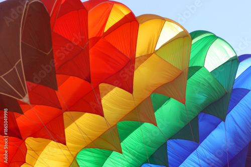 Colorful parachute at action sport meeting. Adrenaline, extreme sports meeting colorful parachute at blue sky