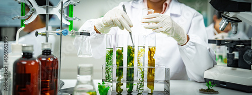Female scientist conducting algae biotechnology research in a modern laboratory, analyzing green biological samples for sustainable energy, environmental innovation, and renewable bioresource develop.