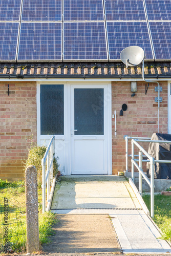 Ramp and handrails leading up to door of house to make access easier