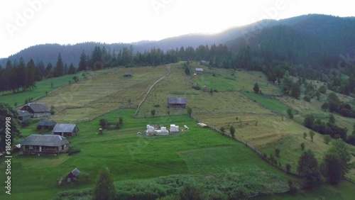 Green grass hill and sunset over mountain