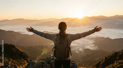 Person Embracing Sunrise Over Mountain Range with Arms Outstretched in a Serene Landscape