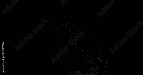 Realistic fire sparks flying through the air in slow motion, isolated on a black background. Perfect as a cinematic VFX overlay, fire particles effect or visual element. Shot in slow motion.
