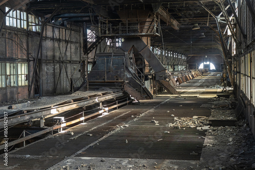 Abandoned industrial hall with conveyor line