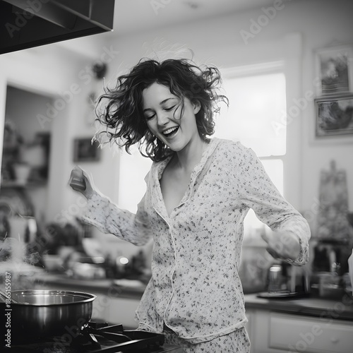 Joyful Morning Scene of a Woman Dancing Casually in Pajamas While Preparing Food at Home, young woman in the kitchen