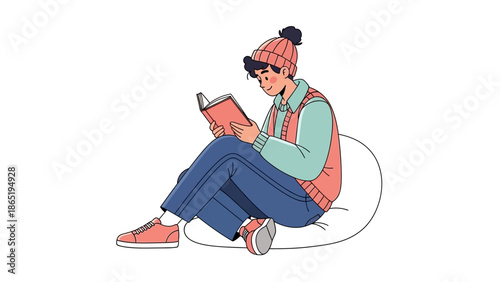 Person Sitting on Beanbag Reading Book in Winter Clothes