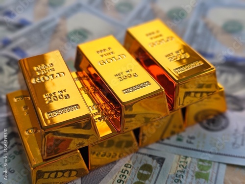 Gold bars stacked on US dollar bills in a financial setting