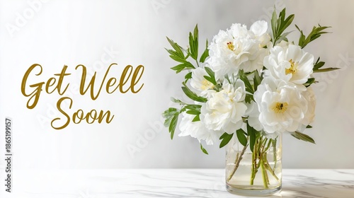 White bouquet of flowers in glass vase with Get Well Soon message  