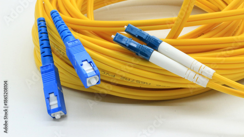 Yellow fiber optic cable with connectors on white background