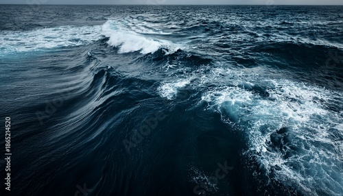 dark ocean water with white foam and waves
