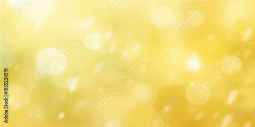 An abstract golden bokeh background features glowing yellow holiday lights with blurred glitter and shiny xmas decorations in a bright defocused circular pattern of glowing gold sparkles