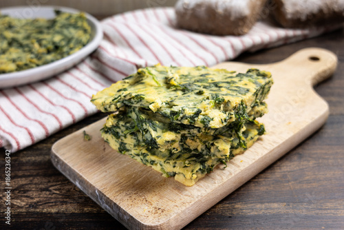 Spinach farinata with bread and kitchen towels