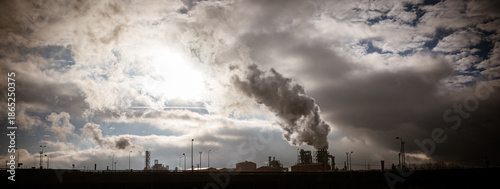 Industrial factory emitting smoke pollution into the atmosphere