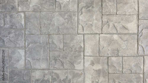 Slika na platnu A detailed close-up of a grey stamped concrete surface, designed with an irregular stone block pattern