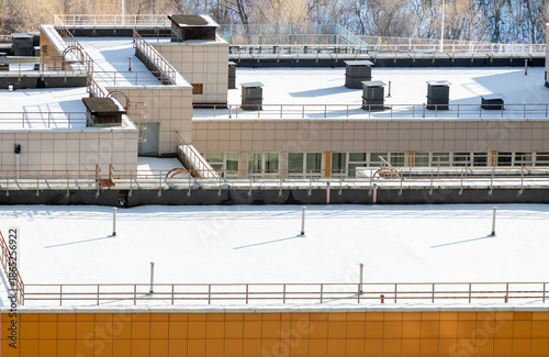 Modern urban building rooftops covered with snow copy space