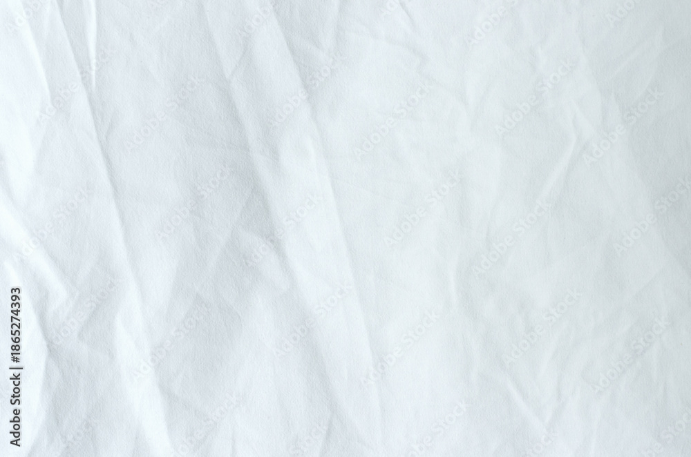 Obraz premium Top view of wrinkles on an unmade bed sheet after waking up in the morning.