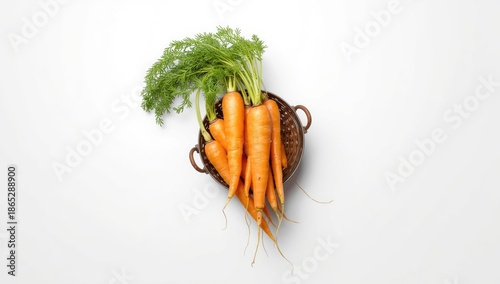 Unwashed yellow carrots in a metal basket for natural food presentation, World Food Day