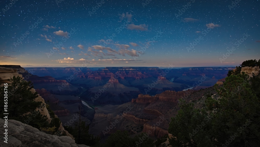 Obraz premium Nighttime scene of the Grand Canyon from Desert View Point with the Colorado River visible, emphasizing natural erosion