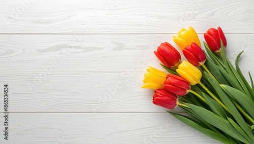 Colorful tulips in full bloom placed on a white wooden table, suitable for floral display or decoration