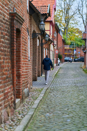 Gasse mit Fussgänger und alten Gebäuden in der Altstadt von Lüneburg in Deutschland