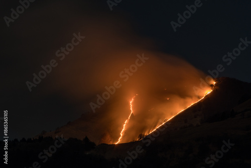 Photos Large wildfire burning on mountain slope at night in mountain