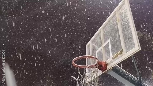 Basketball hoop during evening snowfall winter atmosphere