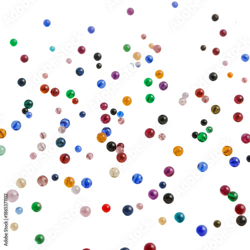 Colorful Beads Scatter on a White Background During a Craft Activity in a Well-Lit Space