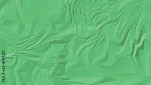 A close up view of a mint green textured surface with irregular patterns and wrinkled and crumpled paper texture.