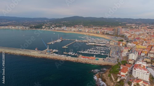 Aerial view flying over palamos harbor and bay