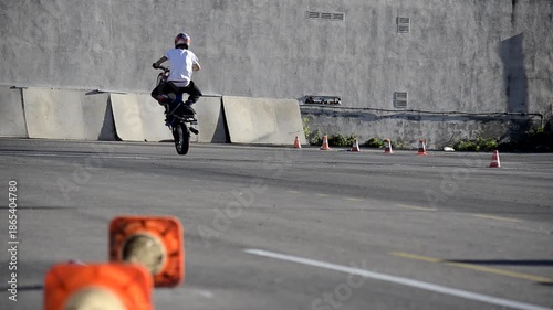 Professional Stunt Rider Doing Motorcycle Tricks on Circuit