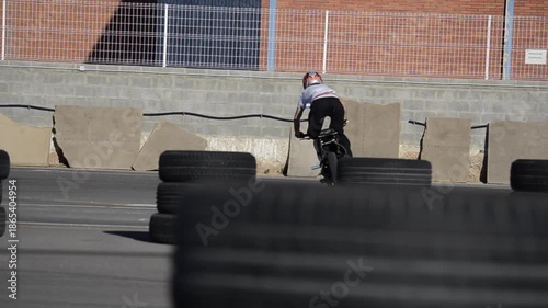 Motorcycle Stunt Rider Performing Tricks on Professional Track