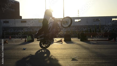 Motorcycle Stunt Rider Doing Tricks at Golden Hour