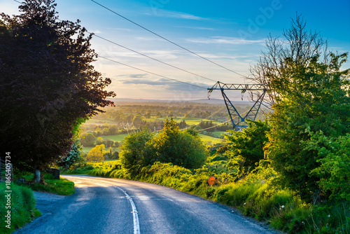 Foto Electricity pylons in the Wicklow Mountains landscape at golden hour