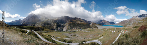 Tableau sur toile Dramatic panoramic view of winding mountain pass roads through alpine valley