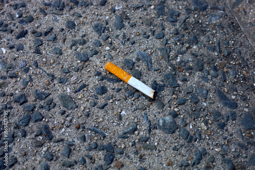 Foto Cigarette butt on the pavement.
