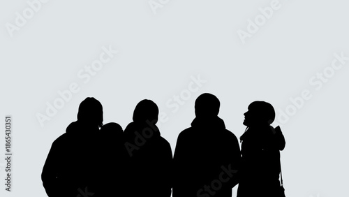 Silhouette of a group of people standing together.