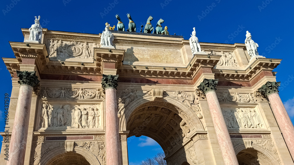 Obraz premium Arc de Triomphe carousel Paris with statues, clear blue sky and open space for text